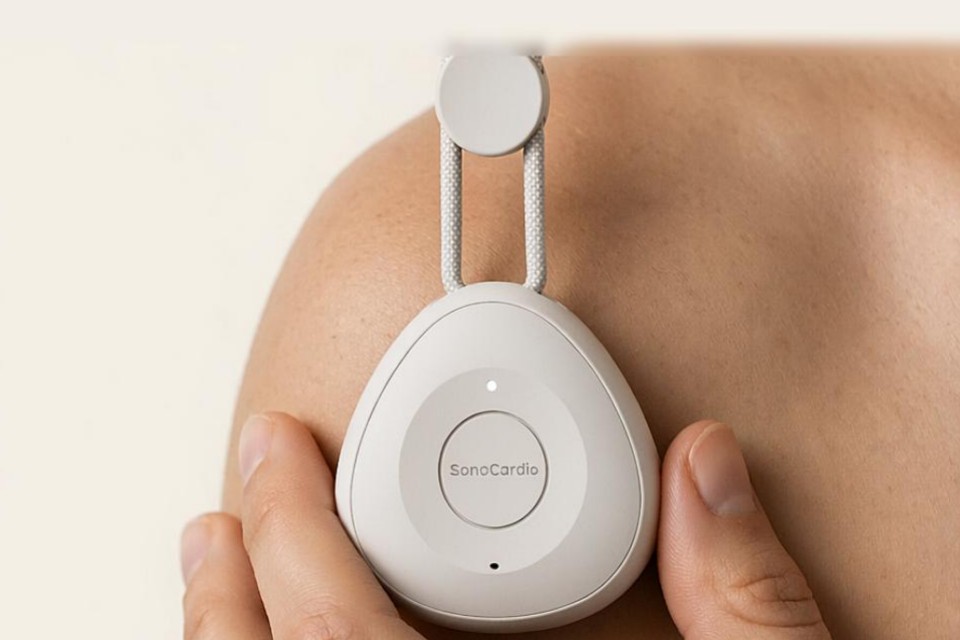Hand holding SonoCardio against the upper chest for a recording